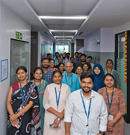 A person is lab coat working with a machine
